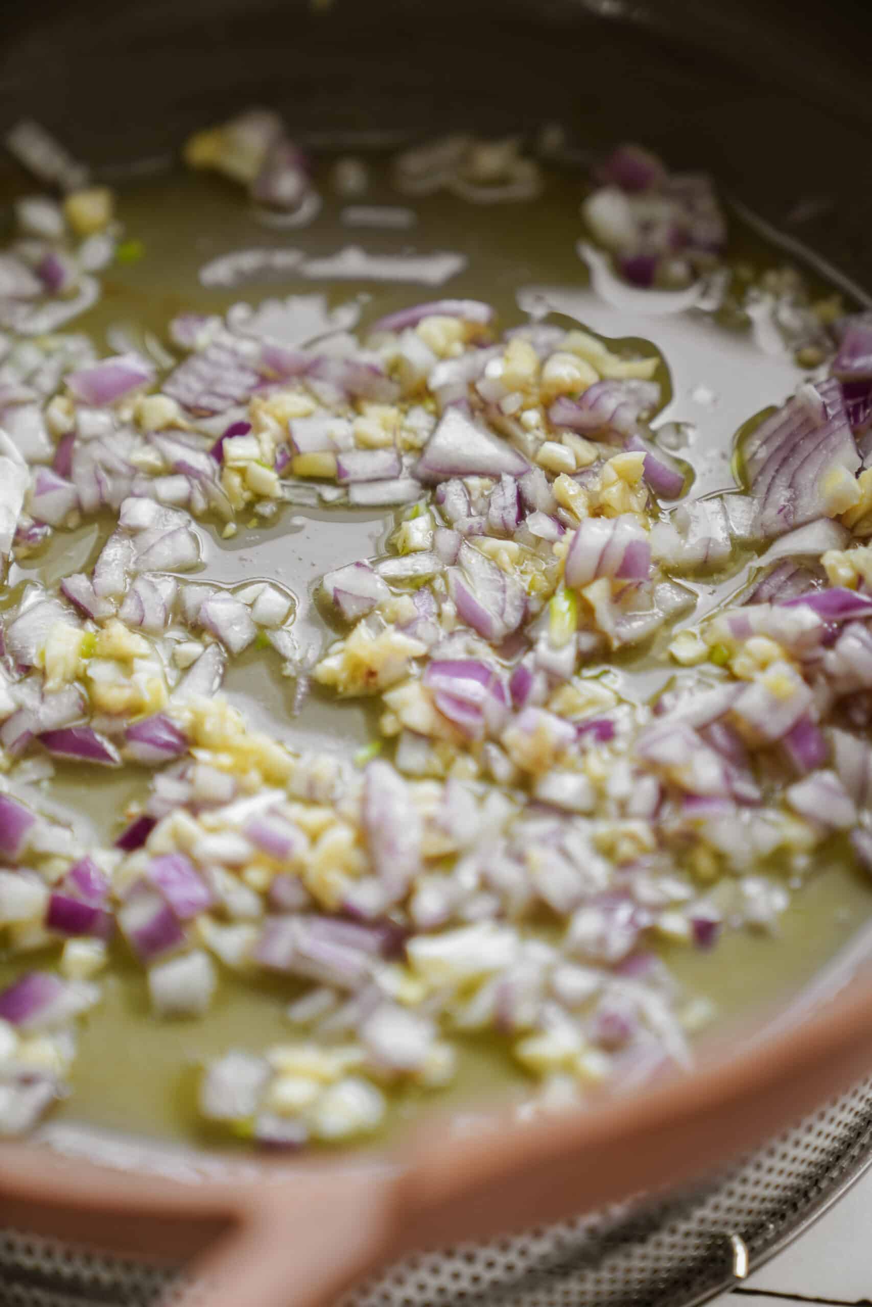 Onion and garlic frying in a pan with oil