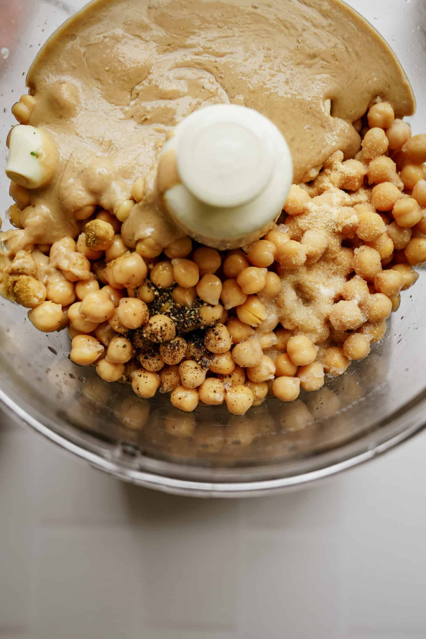 Ingredients for hummus in a food processor 