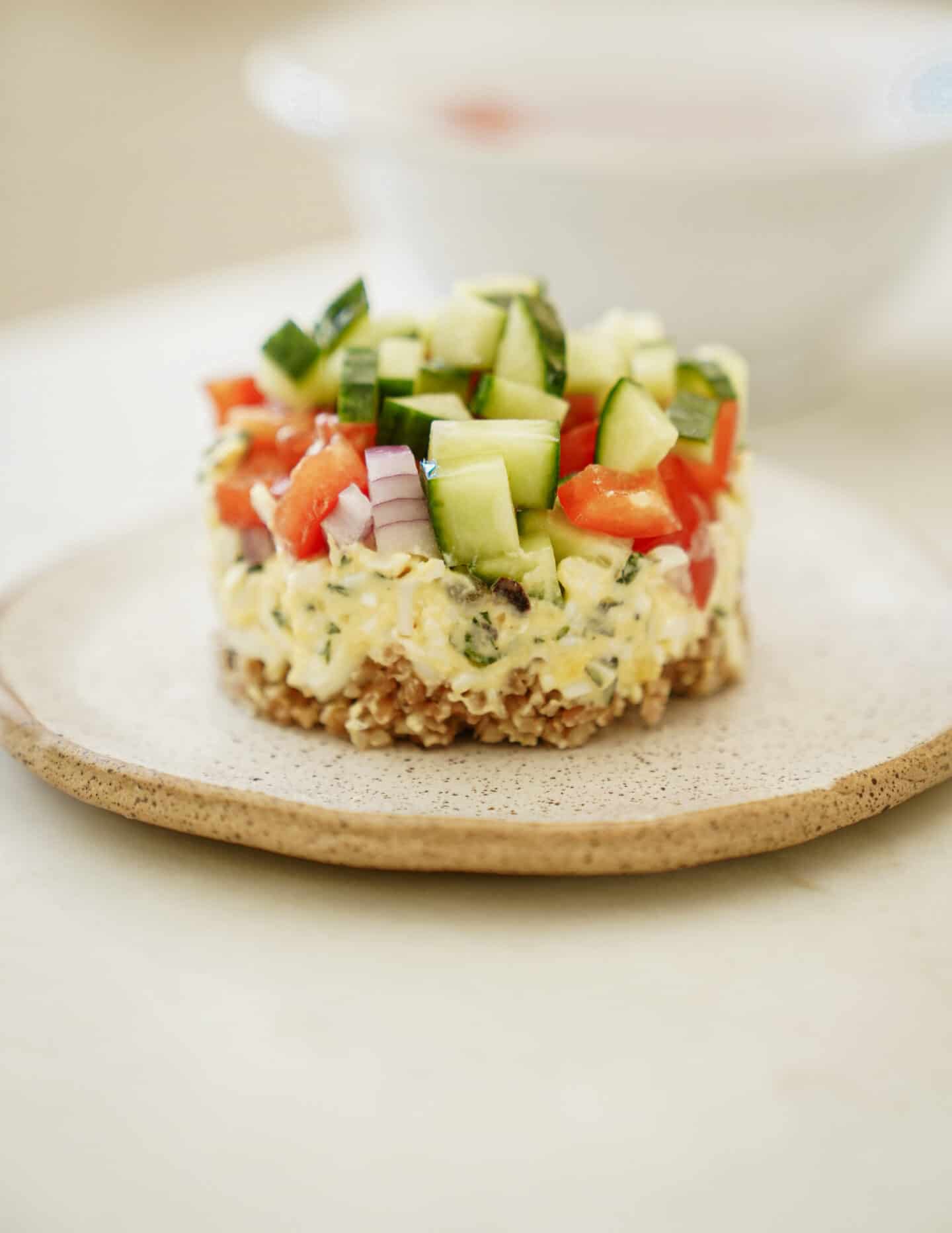 Bulgar wheat salad stack on white plate