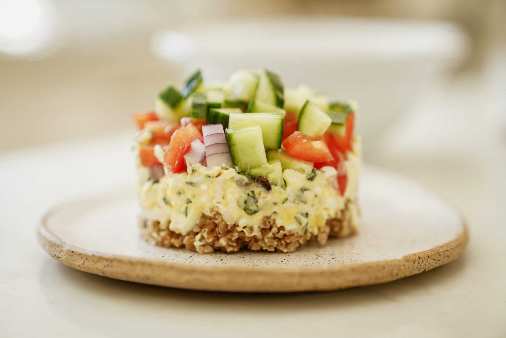 Bulgar wheat salad stack on white plate