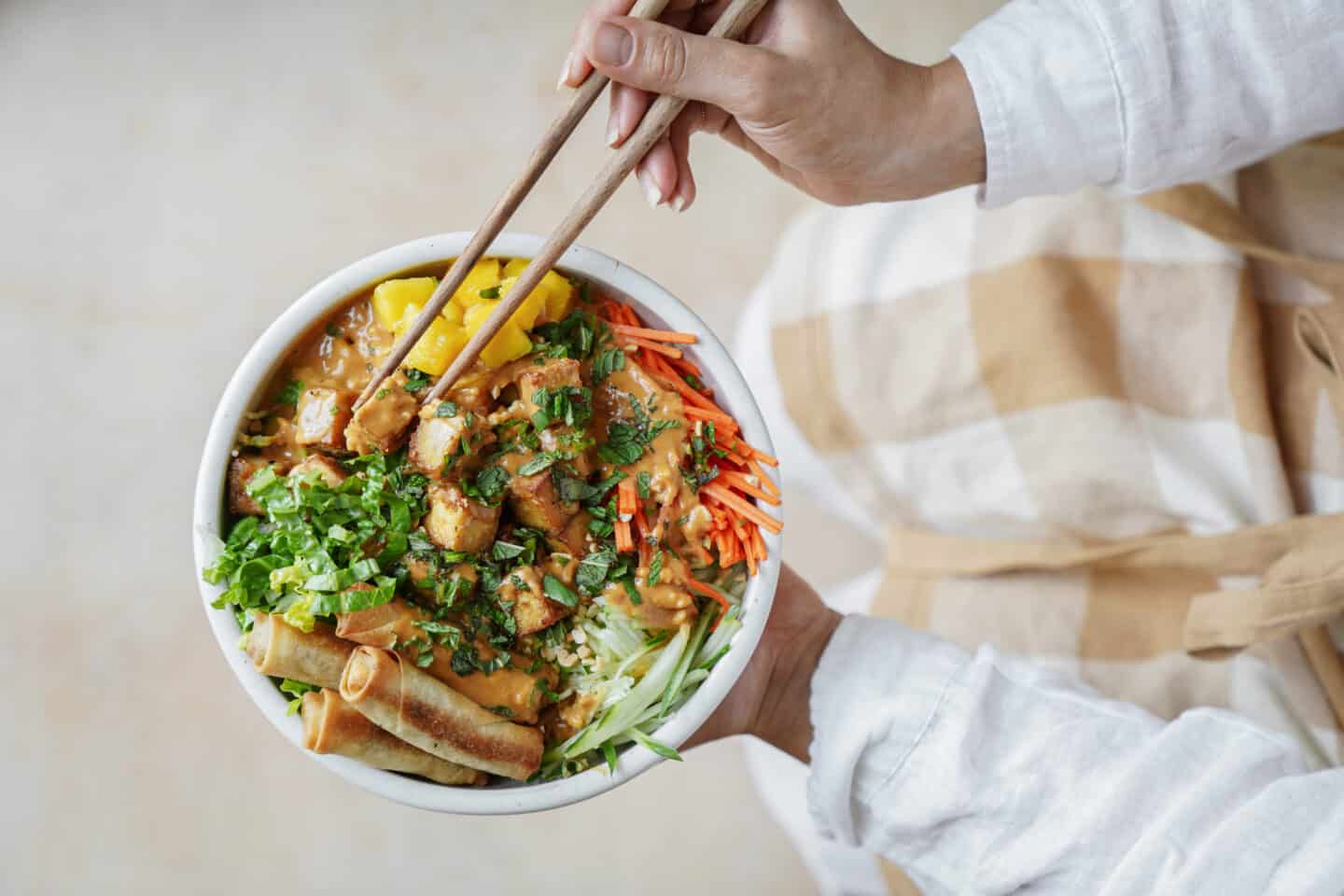 Hands holding chop sticks picking up Vermicelli Noodle Bowl