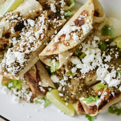 fresh cooked flautas on a plate