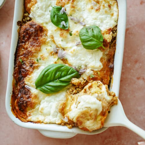 Spatula taking out slice of ravioli casserole