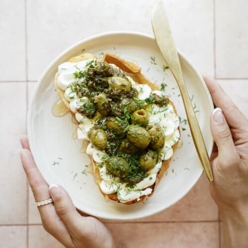 Whipped ricotta toast with olives on top