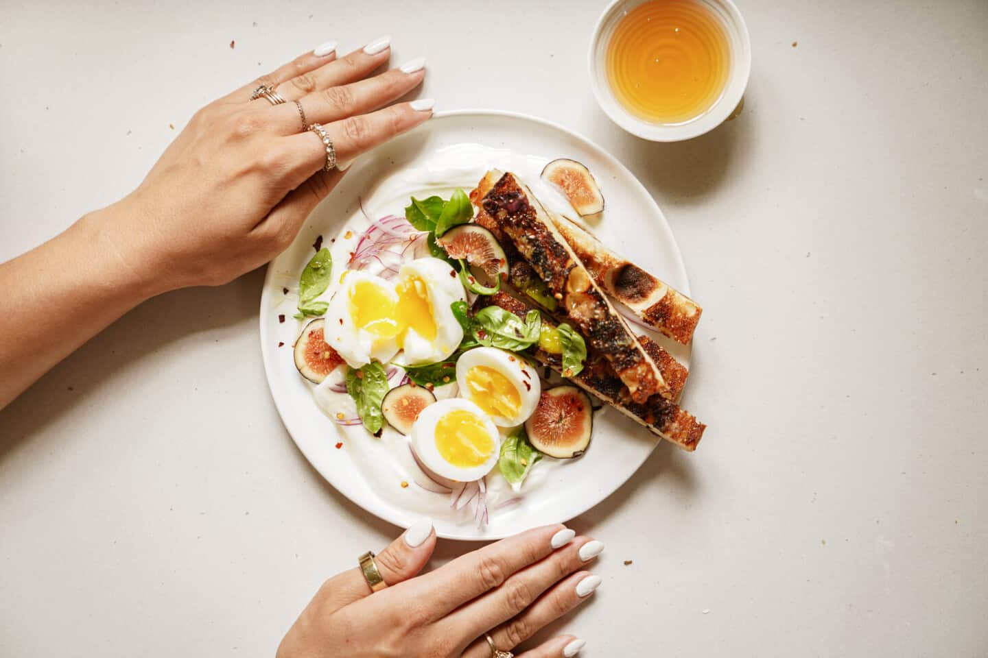 Plate with jammy eggs and some orange juice