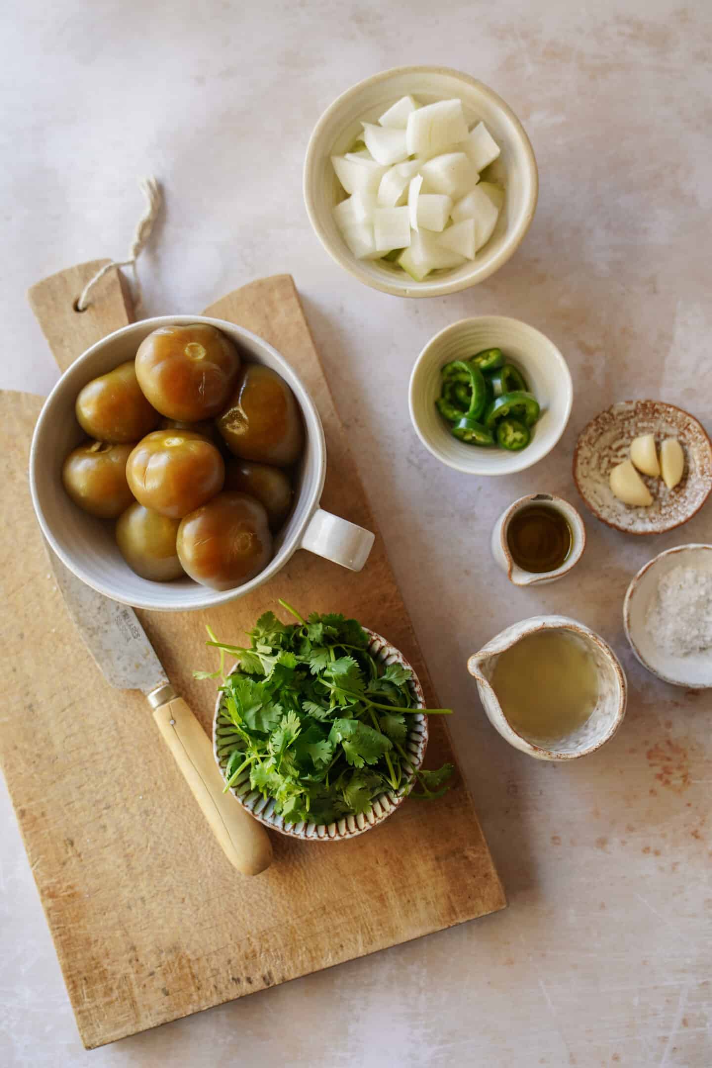 Tomatillo salsa ingredients on cutting board