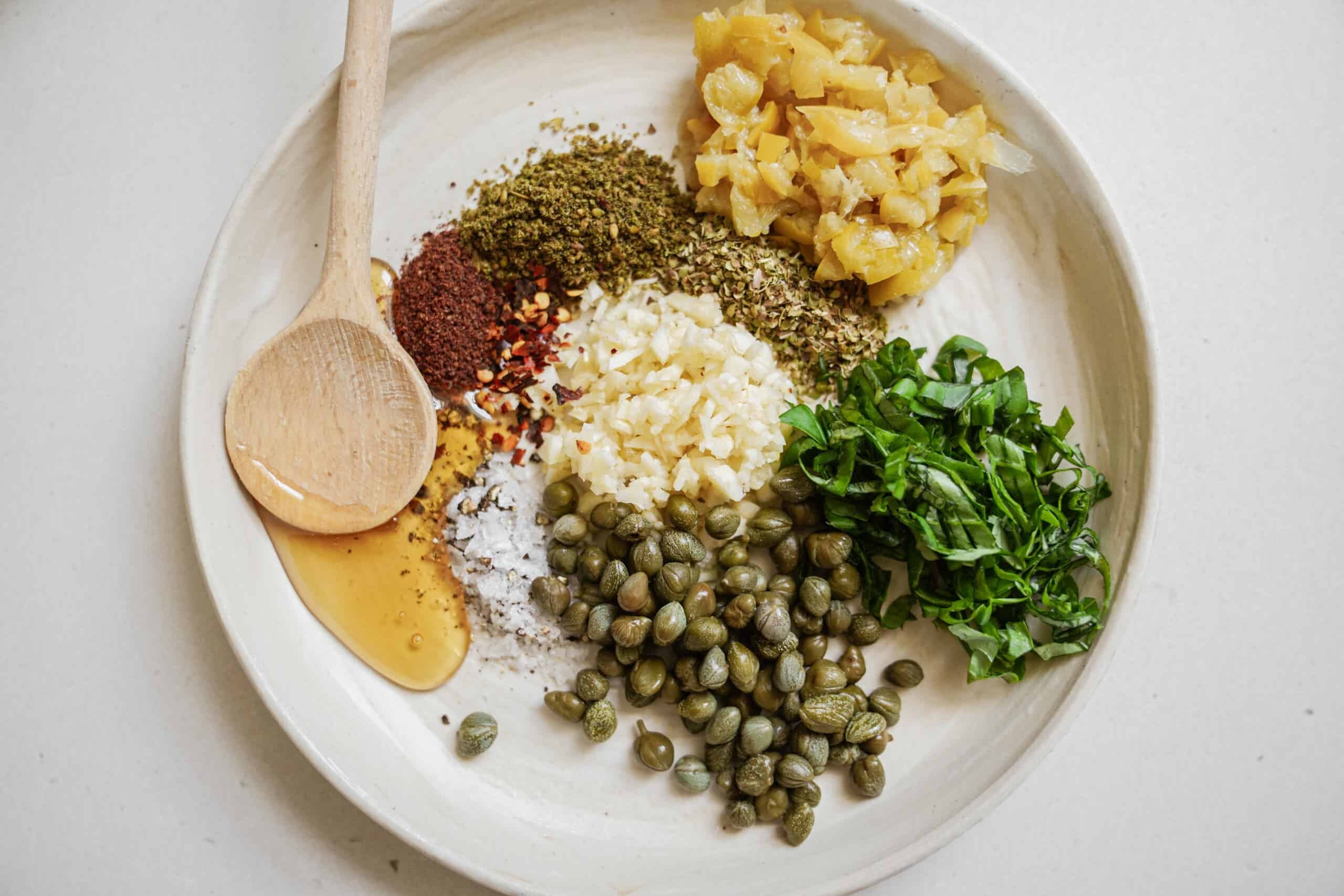 Ingredients laid out on a plate for bread dipping oil