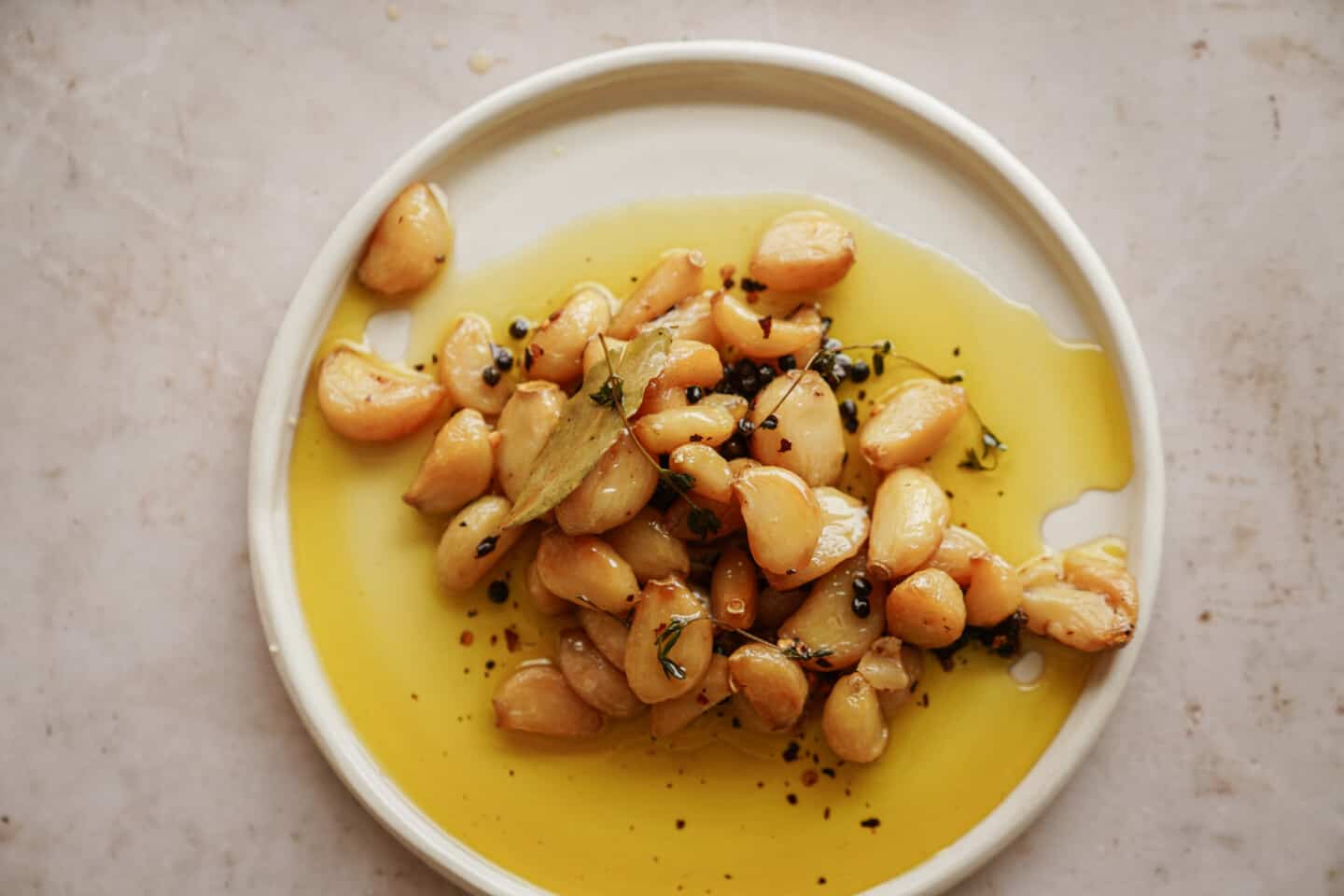 Confit in olive oil on a white plate