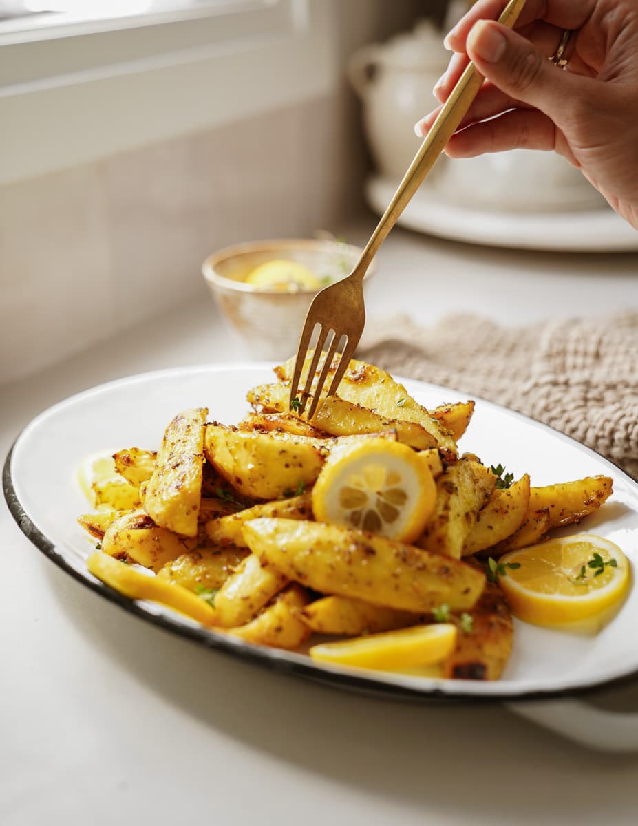 Crispy and easy Greek potatoes on a serving plate