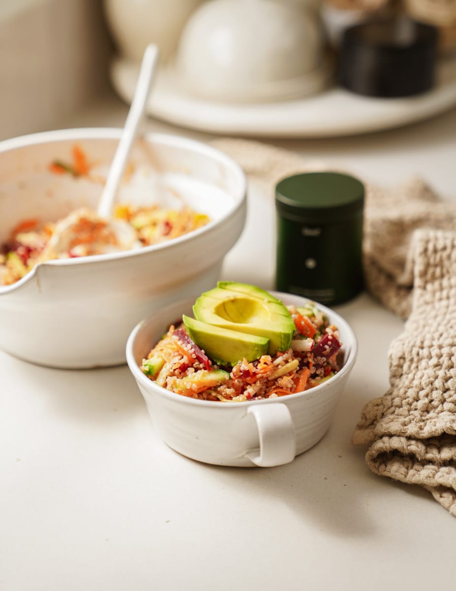 Nourish bowl on counter in white bowl next to serving bowl