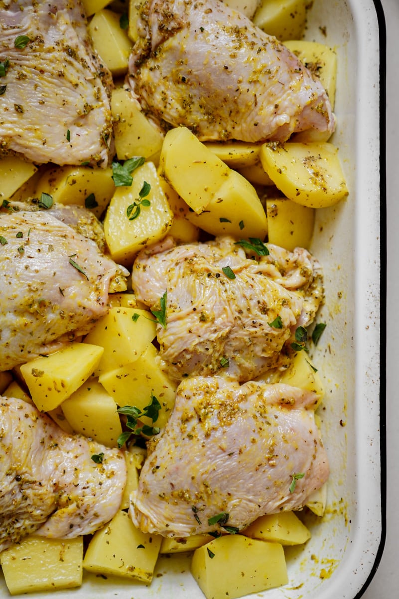 Greek chicken and potatoes in a casserole dish, marinated with a lemon marinade 