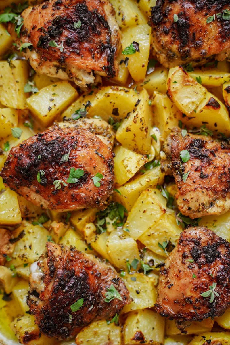 Close up of Greek chicken and potatoes baked in a casserole dish