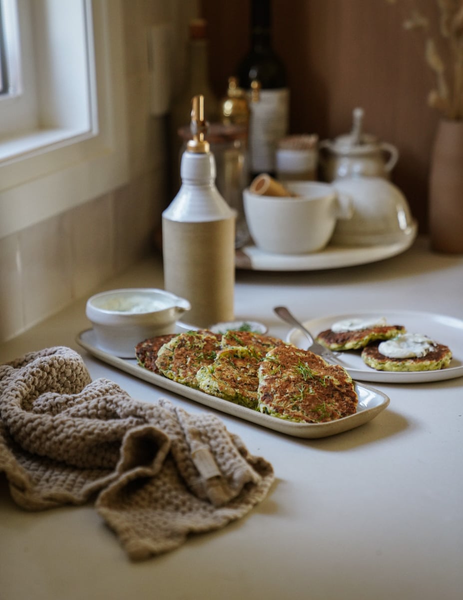 Greek Kolokithokeftedes on a serving dish on the counter