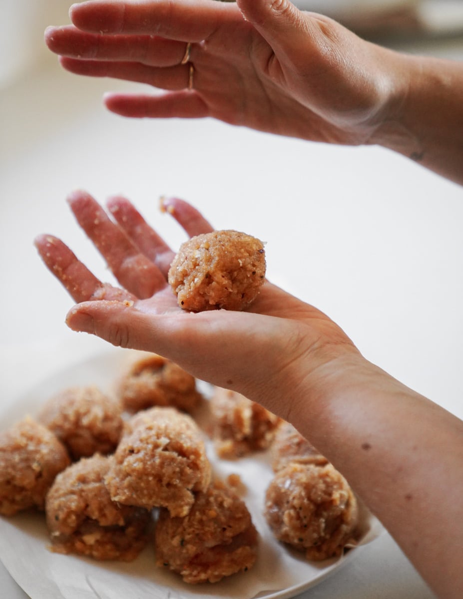 hands rolling firecracker meatballs