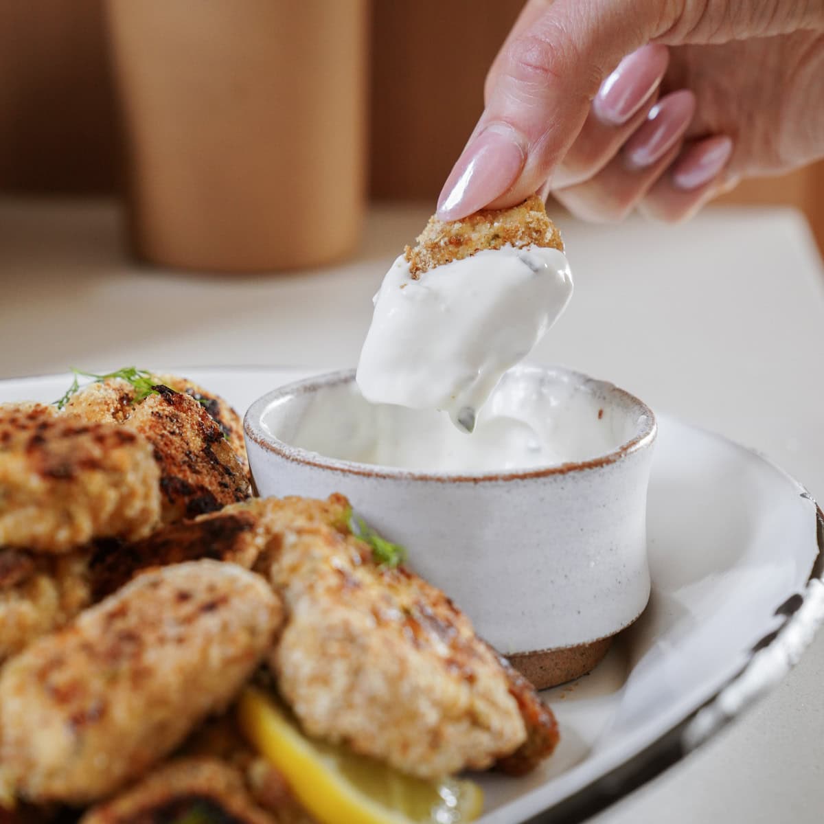 Homemade Chicken Nuggets being dipped into sauce