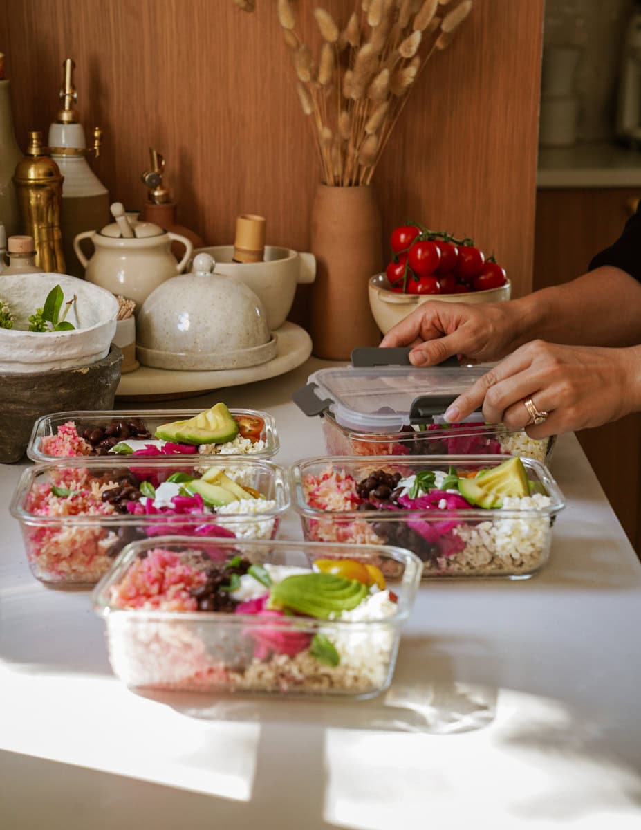 Adding ingredients to chicken rice bowls