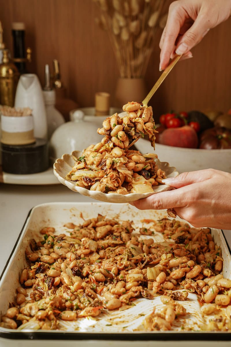 Baked cabbage being scooped out onto a plate