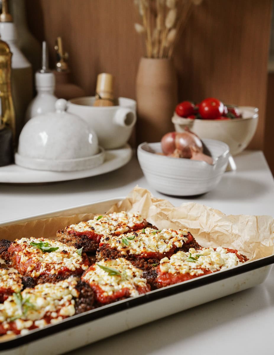 Baking tray with chicken parmesan on it